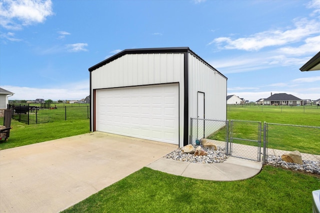 detached garage featuring fence and a gate