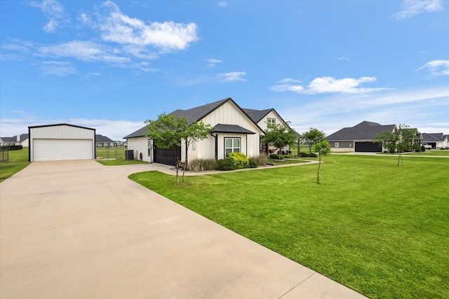 view of front of property featuring a detached garage, an outbuilding, board and batten siding, and a front yard