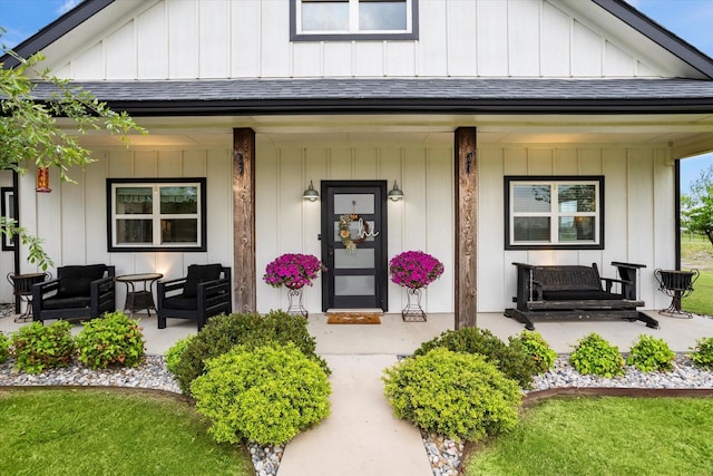 property entrance with a porch, board and batten siding, and roof with shingles
