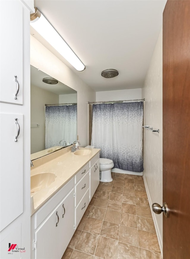 9820 Hillsboro Dr, Shreveport, LA 71118 - full bath featuring double vanity, a sink, baseboards, and toilet
