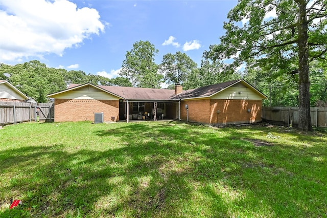 9820 Hillsboro Dr, Shreveport, LA 71118 - back of house featuring a chimney, central AC unit, brick siding, a fenced backyard, and a yard