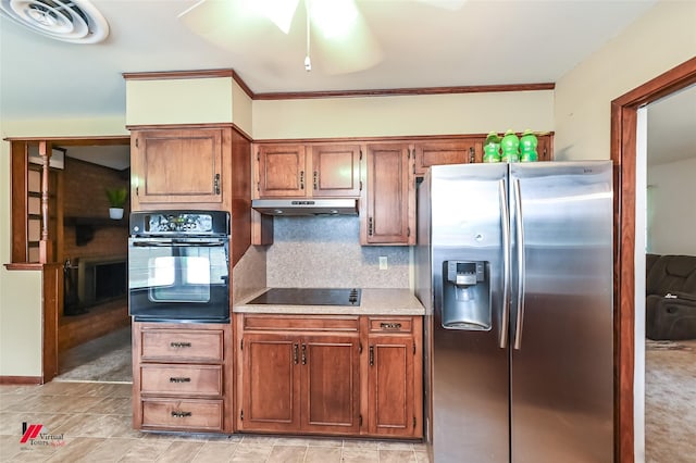 9820 Hillsboro Dr, Shreveport, LA 71118 - kitchen with brown cabinetry, tasteful backsplash, light countertops, black appliances, and under cabinet range hood