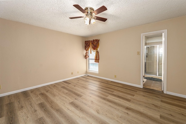 1201 Harwell Dr Unit 225, Arlington, TX 76011 - empty room featuring ceiling fan, a textured ceiling, light wood-style flooring, and baseboards