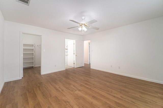 6127 Welden Ct, Fort Worth, TX 76132 - unfurnished bedroom with a walk in closet, wood finished floors, visible vents, and baseboards