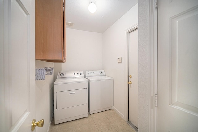 6127 Welden Ct, Fort Worth, TX 76132 - clothes washing area with washer and dryer, cabinet space, visible vents, and light tile patterned floors