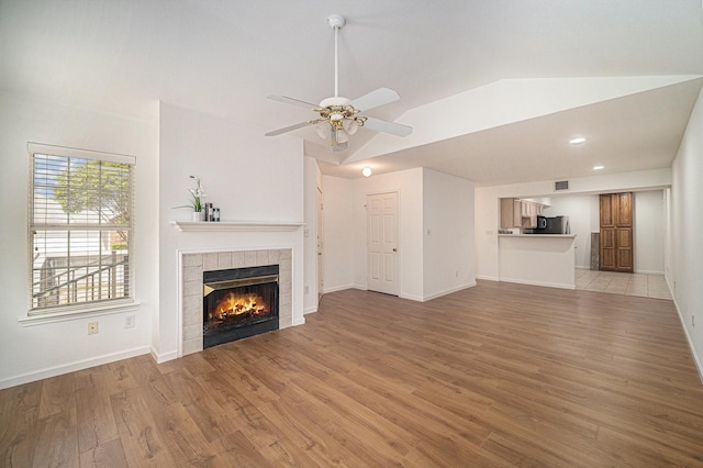 6127 Welden Ct, Fort Worth, TX 76132 - unfurnished living room featuring a fireplace, light wood-style floors, vaulted ceiling, and ceiling fan
