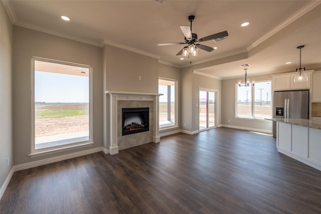 2567 Fm 368, Iowa Park, TX 76367 - unfurnished living room featuring recessed lighting, a tile fireplace, dark wood-type flooring, baseboards, and ceiling fan with notable chandelier