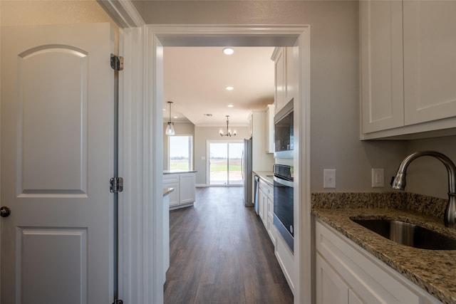 2567 Fm 368, Iowa Park, TX 76367 - kitchen with white cabinets, light stone counters, a sink, appliances with stainless steel finishes, and dark wood-style flooring