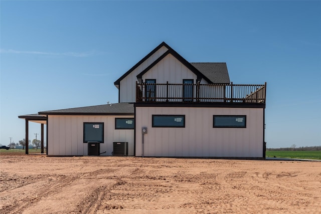 2567 Fm 368, Iowa Park, TX 76367 - back of property featuring board and batten siding, a balcony, and cooling unit