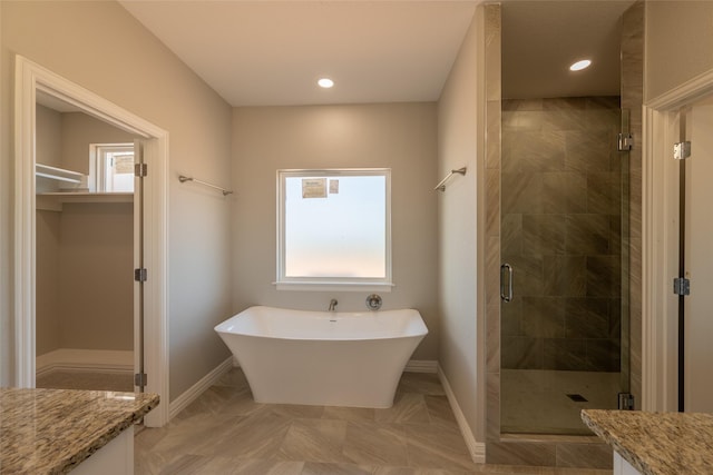 2567 Fm 368, Iowa Park, TX 76367 - full bath with a freestanding bath, a shower stall, a spacious closet, and baseboards