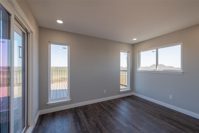2567 Fm 368, Iowa Park, TX 76367 - empty room featuring dark wood finished floors, a healthy amount of sunlight, and baseboards
