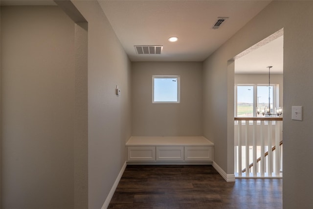 2567 Fm 368, Iowa Park, TX 76367 - hallway with a notable chandelier, baseboards, visible vents, and dark wood-type flooring