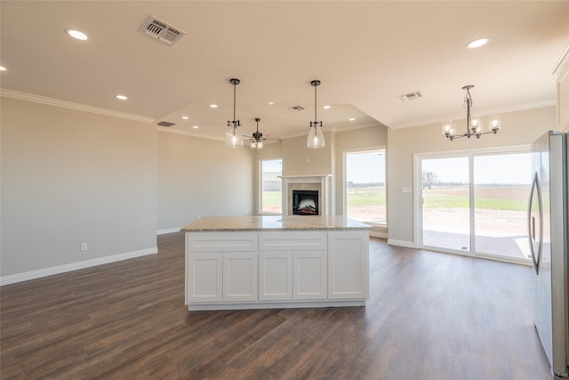 2567 Fm 368, Iowa Park, TX 76367 - kitchen with baseboards, open floor plan, visible vents, and freestanding refrigerator