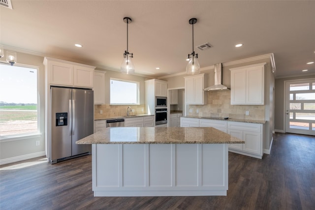 2567 Fm 368, Iowa Park, TX 76367 - kitchen with wall chimney exhaust hood, crown molding, stainless steel appliances, and visible vents