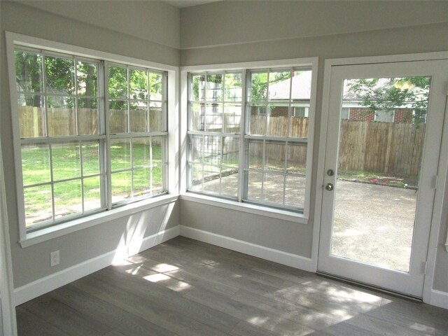 415 Easy St, Marlin, TX 76661 - unfurnished sunroom featuring wood finished floors, baseboards, and a wealth of natural light