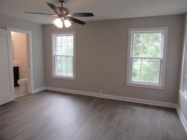415 Easy St, Marlin, TX 76661 - unfurnished room featuring baseboards, wood finished floors, and a healthy amount of sunlight