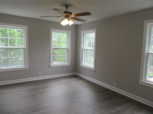 415 Easy St, Marlin, TX 76661 - empty room featuring visible vents, dark wood-style flooring, ceiling fan, and a healthy amount of sunlight