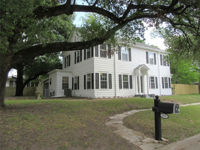 415 Easy St, Marlin, TX 76661 - colonial house featuring fence, cooling unit, and a front yard