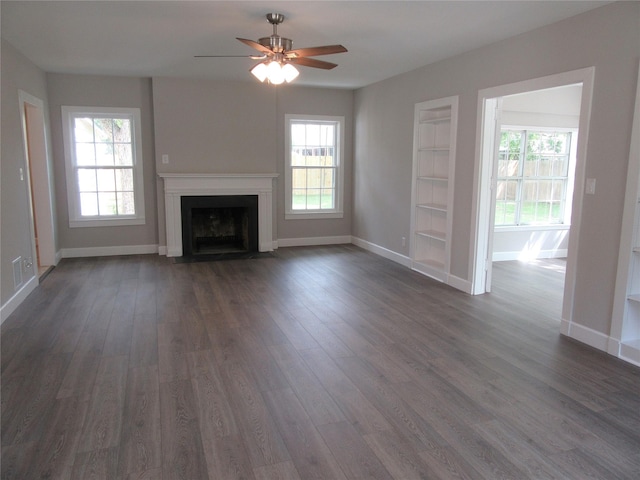 415 Easy St, Marlin, TX 76661 - unfurnished living room with ceiling fan, baseboards, built in features, and dark wood-style floors