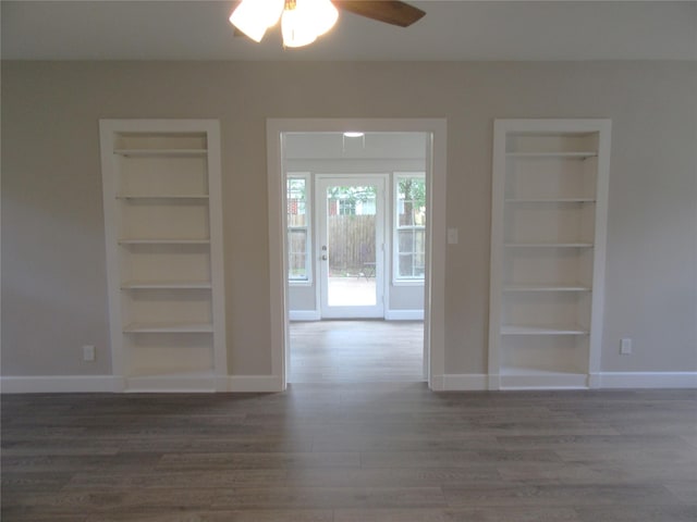 415 Easy St, Marlin, TX 76661 - unfurnished room featuring wood finished floors, built in features, and a ceiling fan