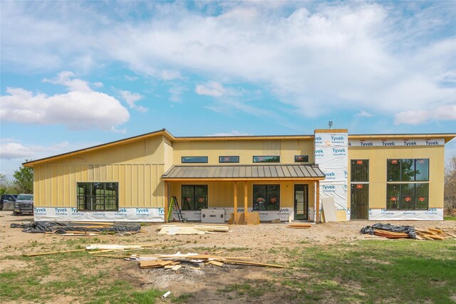 exterior space featuring a standing seam roof, metal roof, and board and batten siding