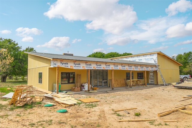 back of property featuring metal roof