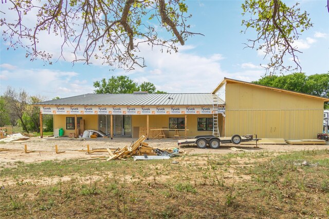 rear view of property with metal roof