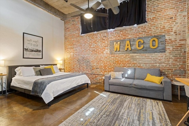 bedroom with brick wall, a high ceiling, and finished concrete floors