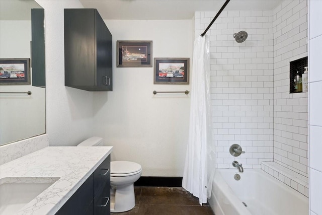 bathroom with baseboards, shower / bath combo, vanity, and toilet