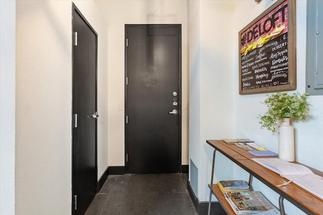 entryway with electric panel and baseboards