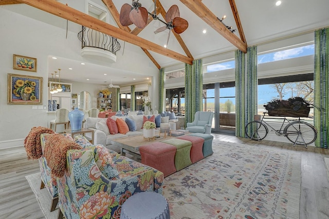 living room with beam ceiling, wood finished floors, high vaulted ceiling, and a ceiling fan