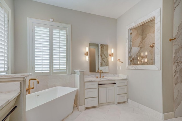 bathroom with walk in shower, a freestanding tub, and vanity