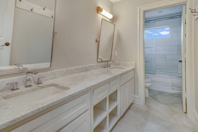 full bathroom featuring tub / shower combination, a sink, double vanity, and toilet