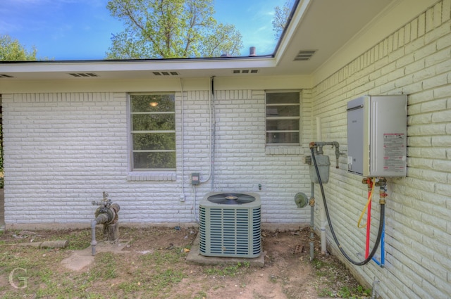 view of home's exterior featuring brick siding and central air condition unit