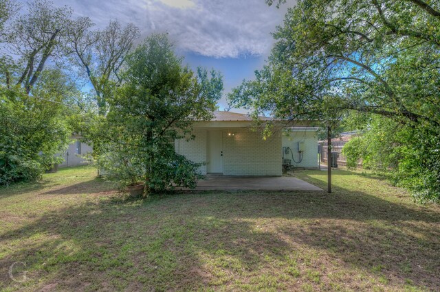 view of yard featuring fence and a patio area
