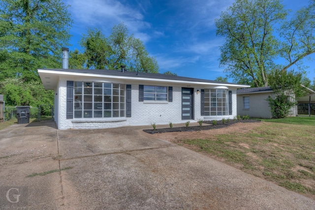 view of front of home with brick siding and concrete driveway