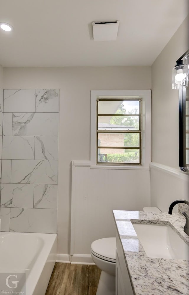 bathroom featuring recessed lighting, wood finished floors, toilet, and vanity