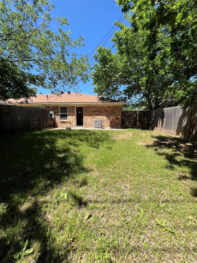 view of yard with a fenced backyard