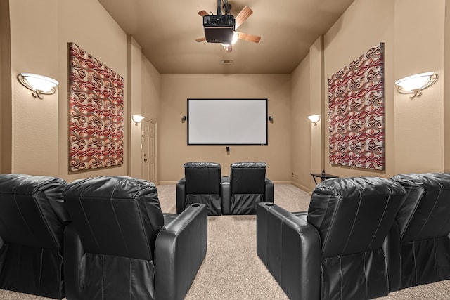 carpeted home theater with ceiling fan and visible vents