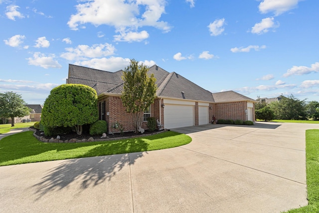 ranch-style house featuring a garage, brick siding, a front yard, and concrete driveway