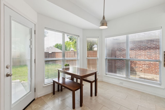 dining room with baseboards and light tile patterned floors