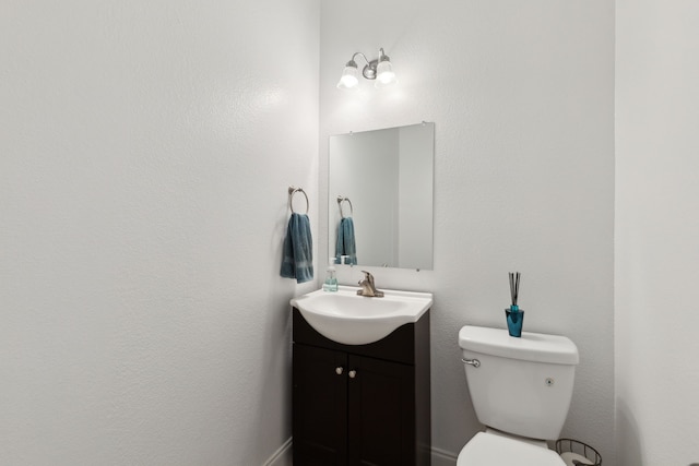 bathroom with toilet and vanity