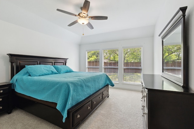 bedroom with a ceiling fan, light colored carpet, and multiple windows