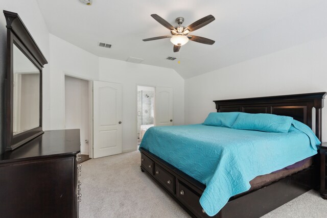 bedroom featuring vaulted ceiling, visible vents, light colored carpet, and ceiling fan