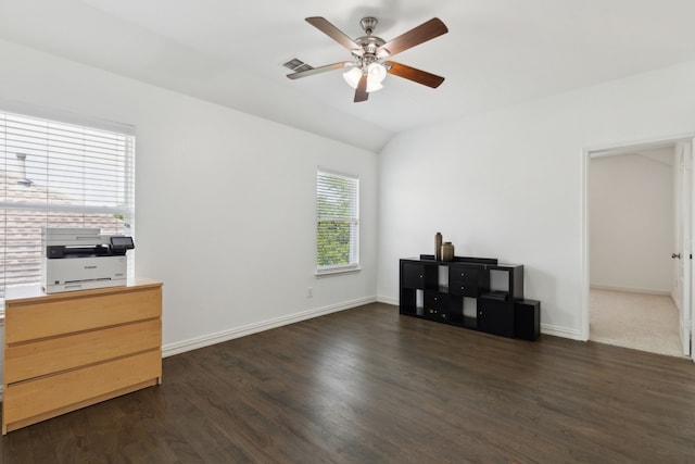 interior space featuring baseboards, visible vents, lofted ceiling, a ceiling fan, and wood finished floors