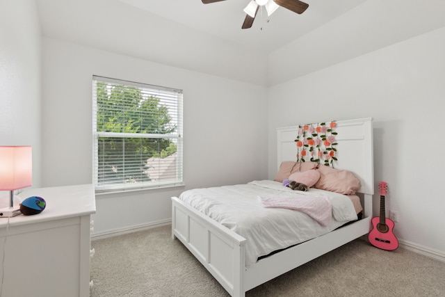 bedroom with ceiling fan, lofted ceiling, baseboards, and light carpet