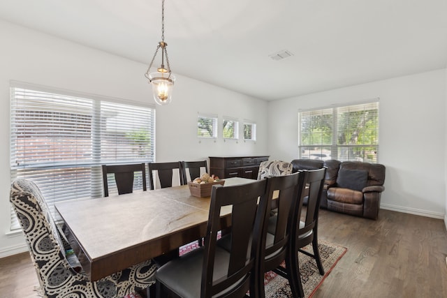 dining room with baseboards, wood finished floors, and visible vents