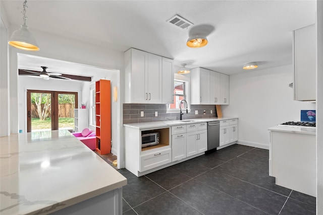 2744 Bay Meadows Ct, Farmers Branch, TX 75234 - kitchen featuring a sink, decorative backsplash, white cabinetry, stainless steel dishwasher, and plenty of natural light