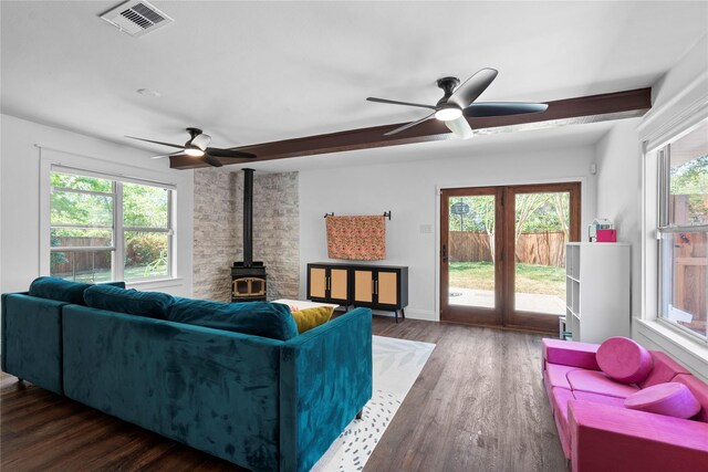 2744 Bay Meadows Ct, Farmers Branch, TX 75234 - living area with a wood stove, a ceiling fan, and healthy amount of natural light