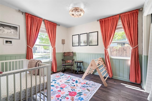2744 Bay Meadows Ct, Farmers Branch, TX 75234 - bedroom with a wainscoted wall, wood finished floors, and a crib